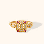 14K gold vintage-style ring with pink baguette stones and white diamonds on cream background.