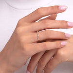 Minimal baguette gold ring on woman's hand, featuring a sleek and modern design