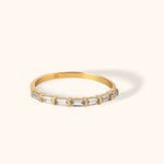 Minimal 14K gold ring featuring a sleek row of baguette-cut stones in a classic bar design