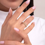 Woman's hand wearing a 14K gold ring with baguette stones arranged in a crown-like pattern