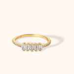 Elegant 14K yellow gold ring featuring a row of baguette-cut diamonds with pavé diamond band, ideal for stacking or special occasions