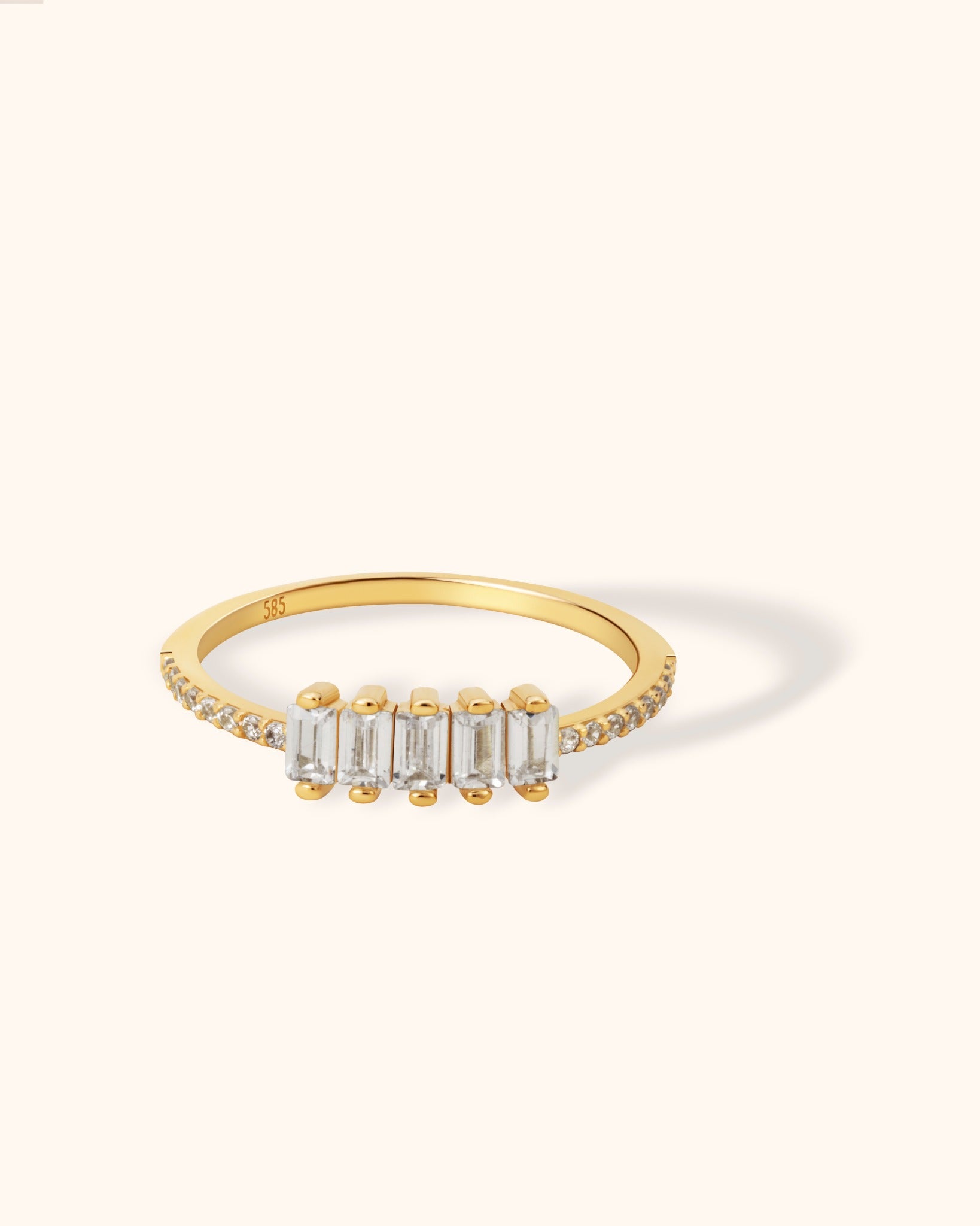 Elegant 14K yellow gold ring featuring a row of baguette-cut diamonds with pavé diamond band, ideal for stacking or special occasions