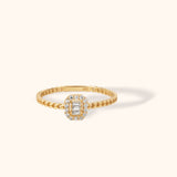 14K gold twisted rope band ring with baguette center stones and pavé halo setting