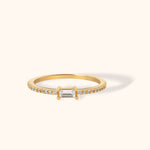 Elegant 14K gold ring with a central baguette-cut stone and pavé-set band, ideal for stacking or solo wear