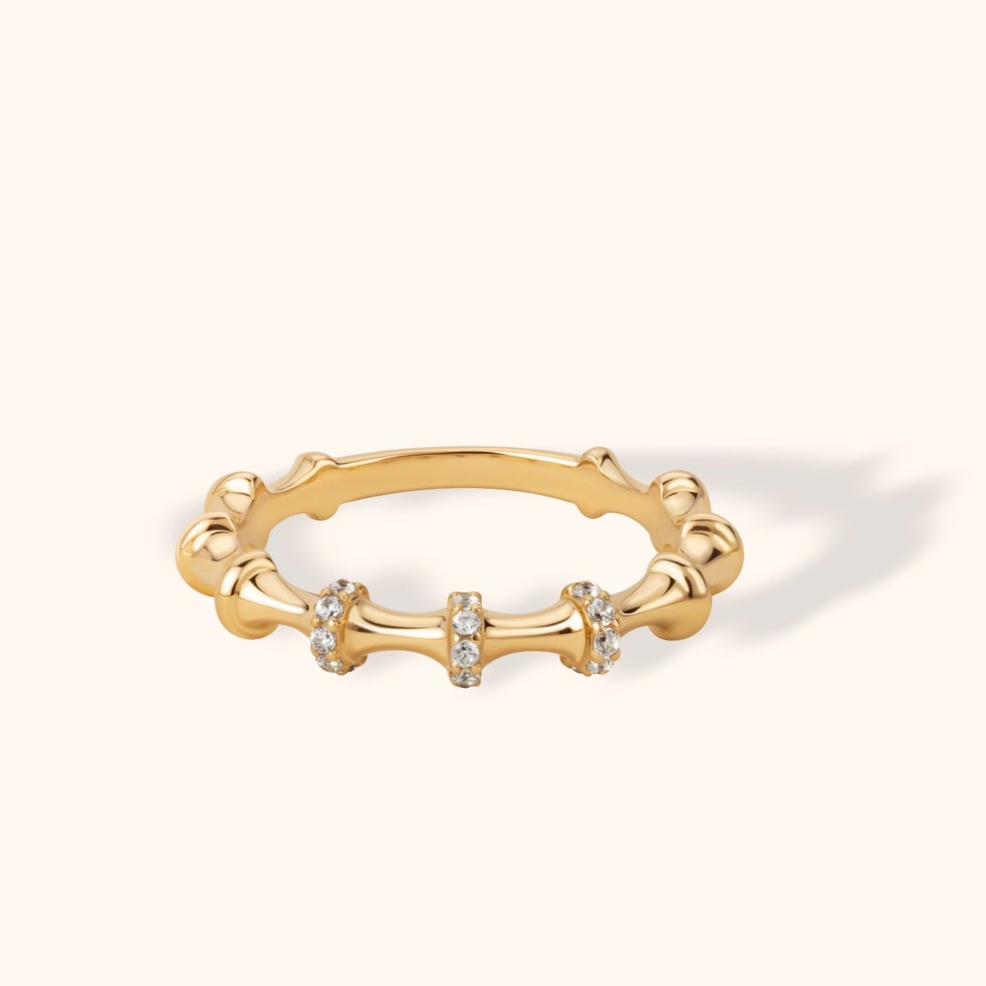 14K gold bamboo-inspired ring featuring pavé-set stones on three curved segments, perfect for stacking or wearing solo