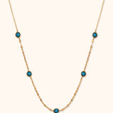 14K gold necklace with bezel-set blue topaz gemstones and dainty chain