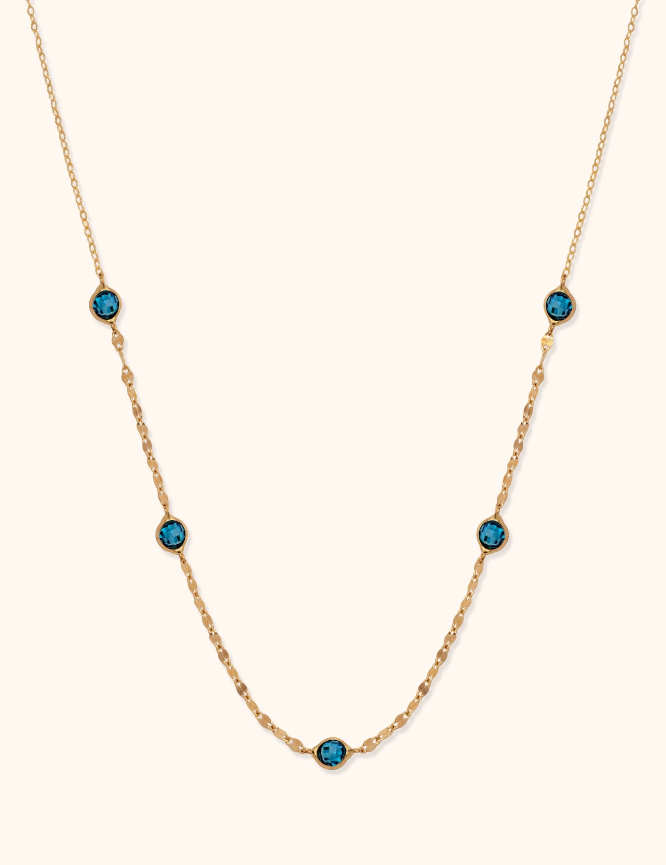 14K gold necklace with bezel-set blue topaz gemstones and dainty chain