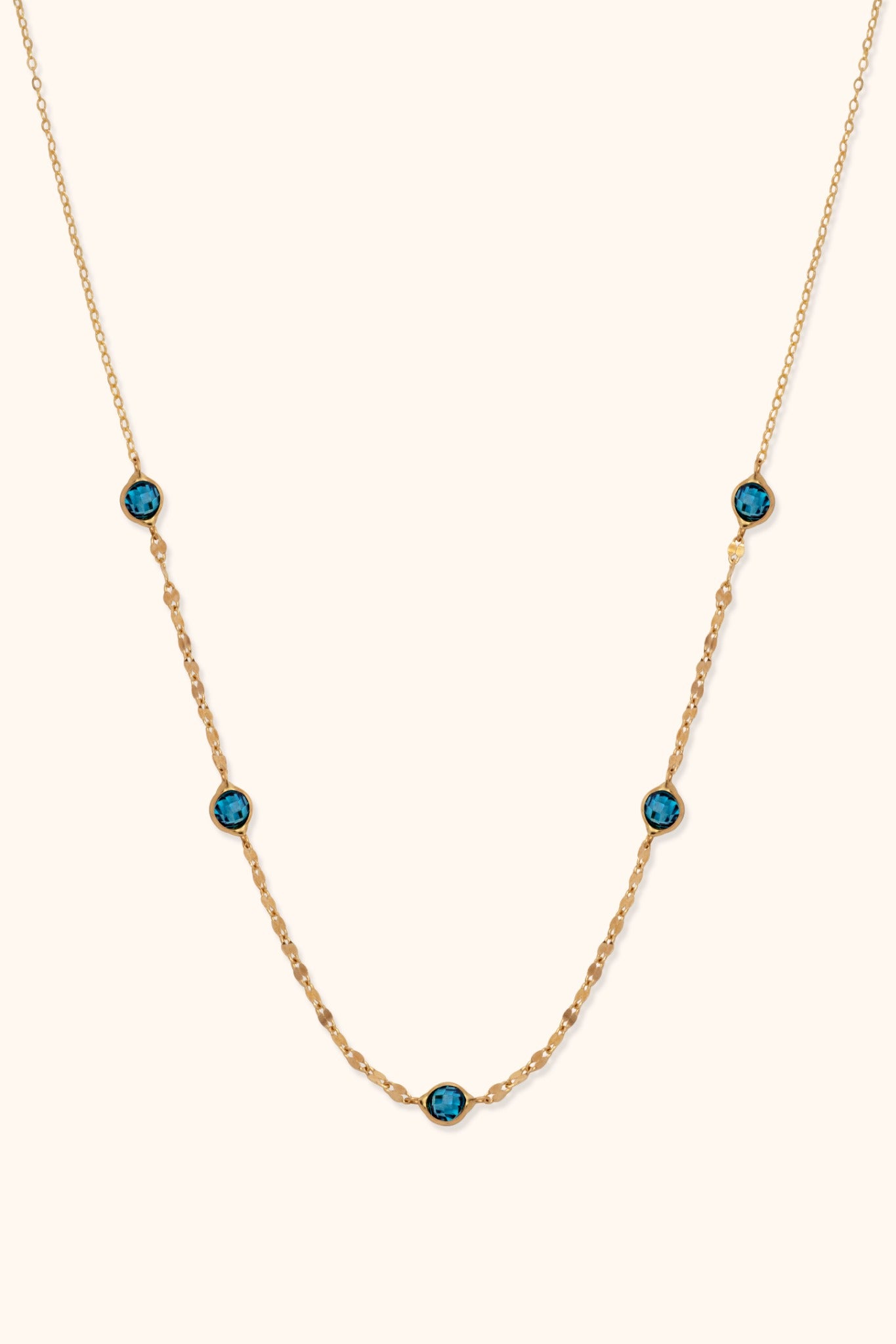 14K gold necklace with bezel-set blue topaz gemstones and dainty chain