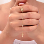 Delicate 14k gold rosary bracelet with Virgin Mary medallion and cross charm held between hands

