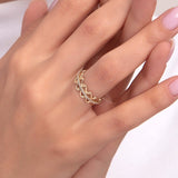 Close-up of a woman’s hand wearing a 14K gold chain link ring with crown-style double-row detailing