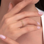 Close-up of woman's hand wearing a 14K gold ring with interlocking chain link design, minimal and modern style