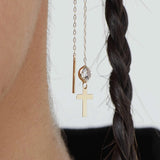 14K gold threader earrings with cross charm and clear crystal bead on model