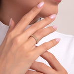 Woman wearing a crown-style 14K gold eternity ring with white stones and bead detailing