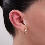 14K Gold Curated Ear Stack – Featuring emerald CZ stud, baguette CZ curved crawler, pave square stud, and classic hoop for multiple ear piercings