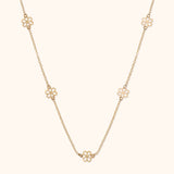 14K gold necklace with open flower station charms evenly spaced on delicate chain
