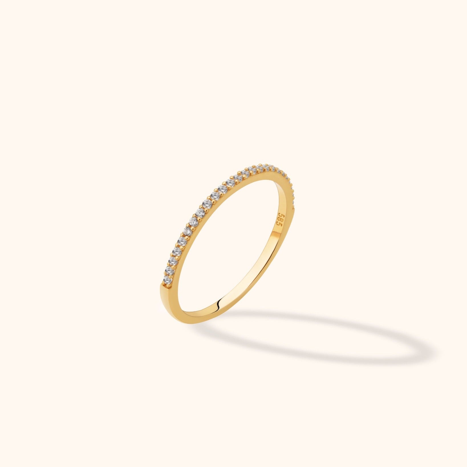 14K gold ultra-thin eternity ring with pavé diamonds encircling the full band in a delicate stacking style