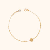 Minimalist 14K gold bracelet with round disc charm on delicate chain