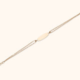 14K gold double chain bracelet with blank ID plate and teardrop crystal charm