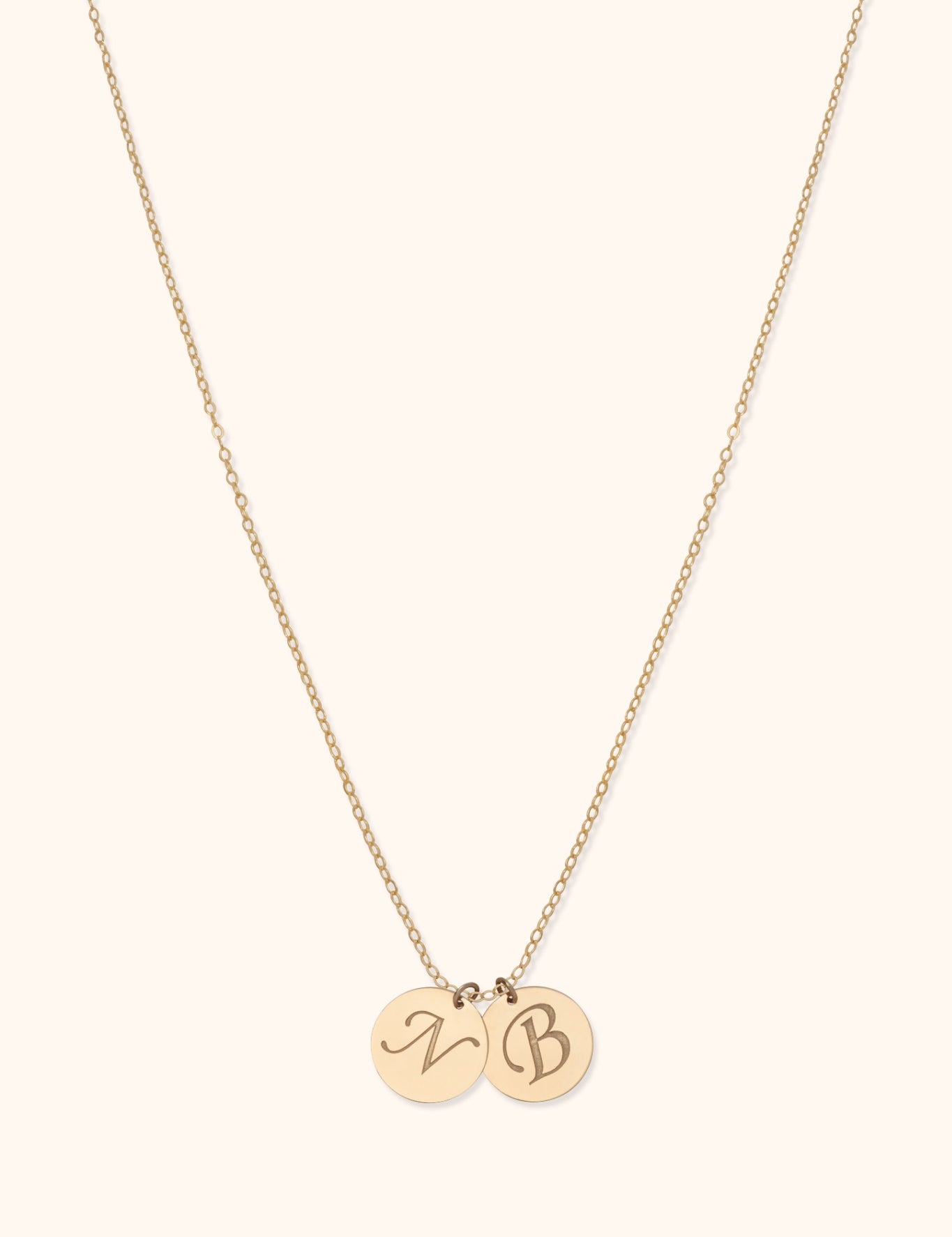 14K gold necklace with two engraved initial discs on delicate chain