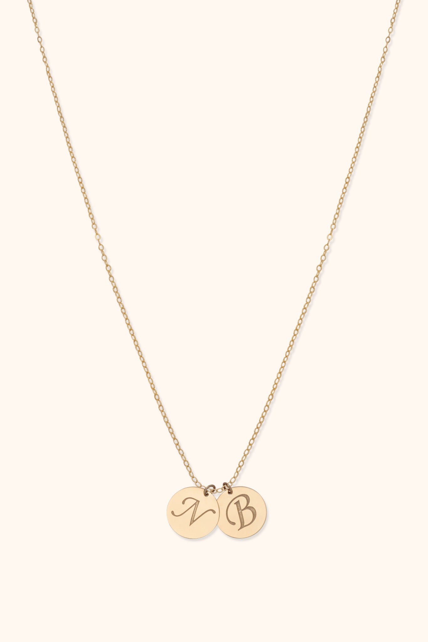 14K gold necklace with two engraved initial discs on delicate chain