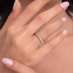 Model showcasing a bold 14K gold ring with double zigzag textures on manicured hands