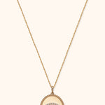 14K gold medallion necklace with evil eye design and diamond halo on twisted rope pendant