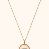 14K gold medallion necklace with evil eye design and diamond halo on twisted rope pendant