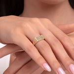 Model wearing a 14K gold five-row pavé diamond ring with a tapered wide band