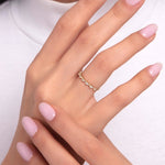 Model hand wearing a delicate 14K gold ring with five sparkling zirconia stones
