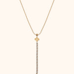 14K gold necklace with floral charm and vertical row of crystals forming a drop pendant