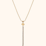 14K gold necklace with floral charm and vertical row of crystals forming a drop pendant