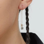 14K gold flower threader earrings with crystal detail worn on model