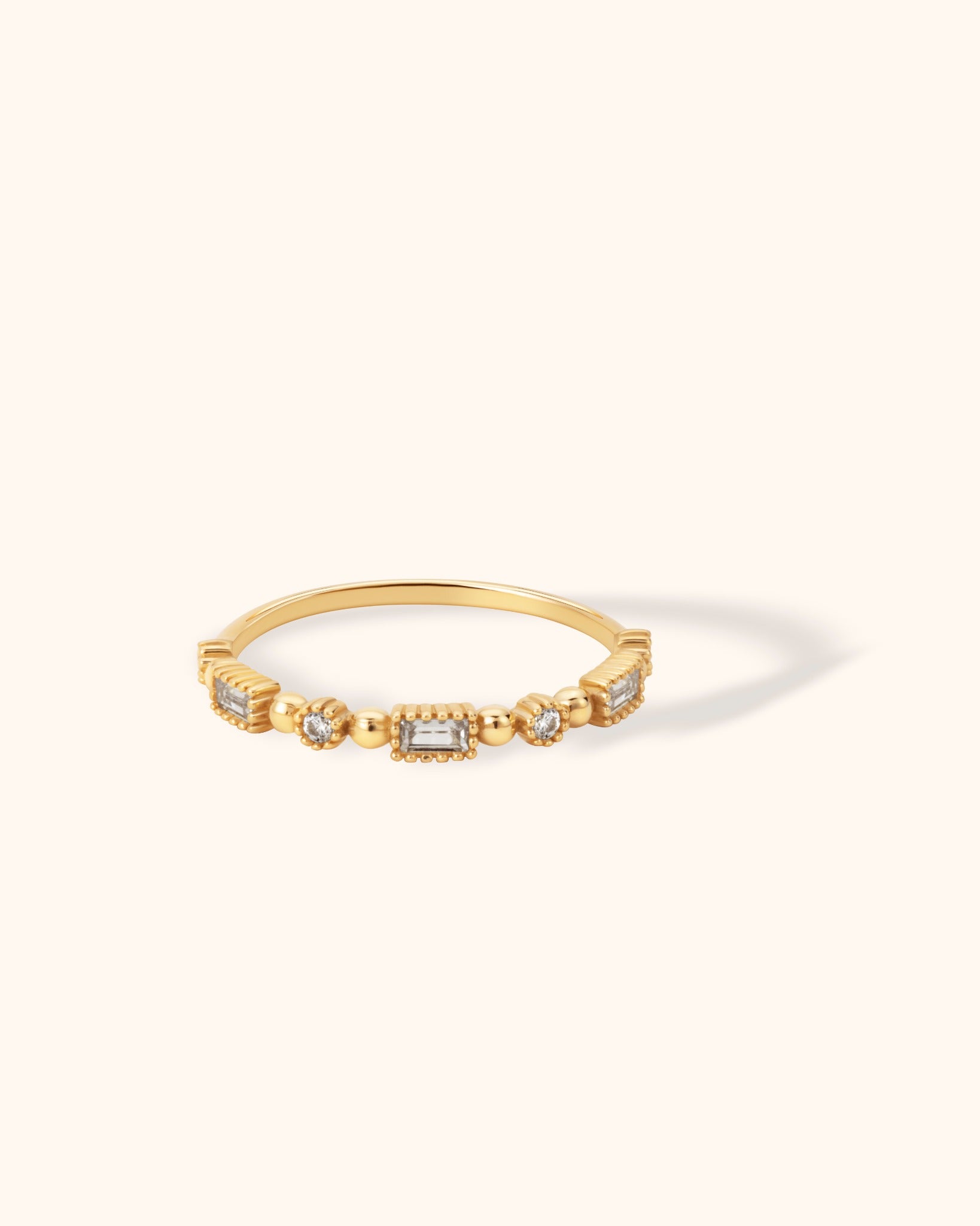 14K gold ring with alternating baguette and round-cut stones in a structured bead-accented setting