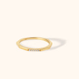 Modern 14K gold octagon-shaped ring featuring five small round diamonds on a flat surface