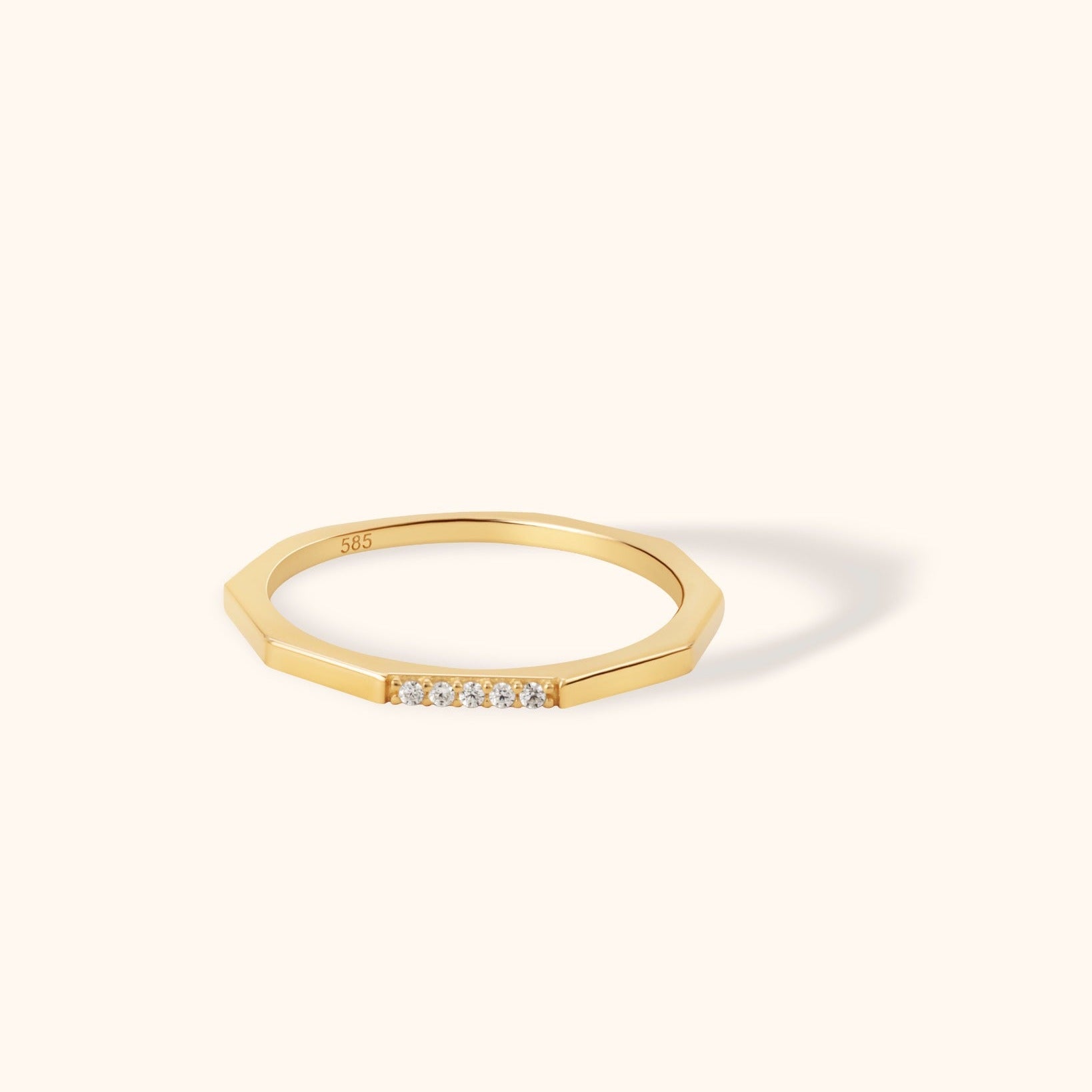 Modern 14K gold octagon-shaped ring featuring five small round diamonds on a flat surface