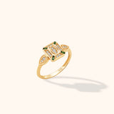 14K gold ring with green emerald baguettes and diamonds in an Art Deco evil eye geometric design