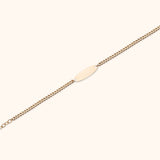 14K gold bracelet with ID plate and pink teardrop gemstone charm