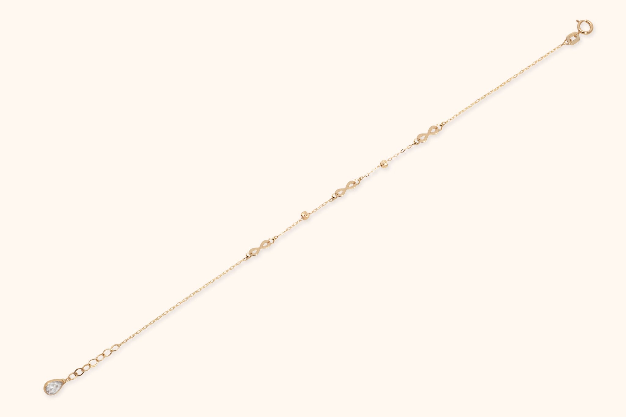 14K gold infinity chain bracelet with bead accents on white background