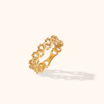 Intricate 14k gold ring with floral and bead-like detailing on cream background

