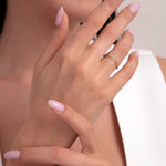 Woman wearing a 14K gold chain link ring with organic texture, elegant minimalist jewelry close-up