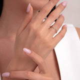 Woman wearing a 14K gold chain link ring with organic texture, elegant minimalist jewelry close-up