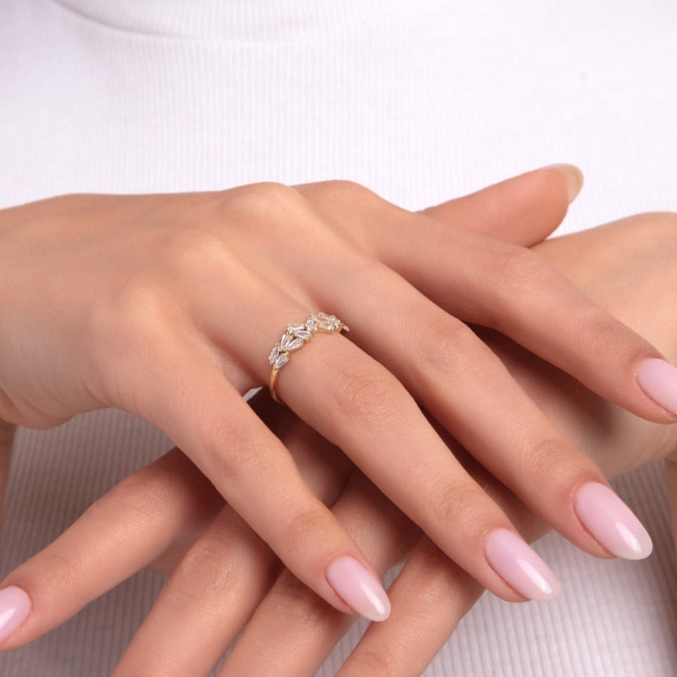 Woman wearing a 14K gold ring with marquise-shaped stones in a leaf-like arrangement
