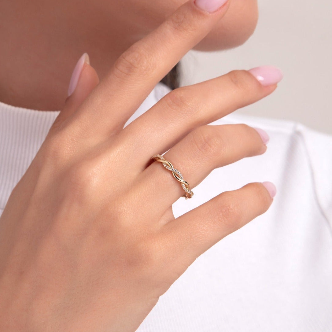 Woman wearing a 14K gold ring with marquise-shaped diamond details, hand close-up