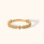 Vintage-inspired 14K gold ring with milgrain detail and diamond accents in geometric settings