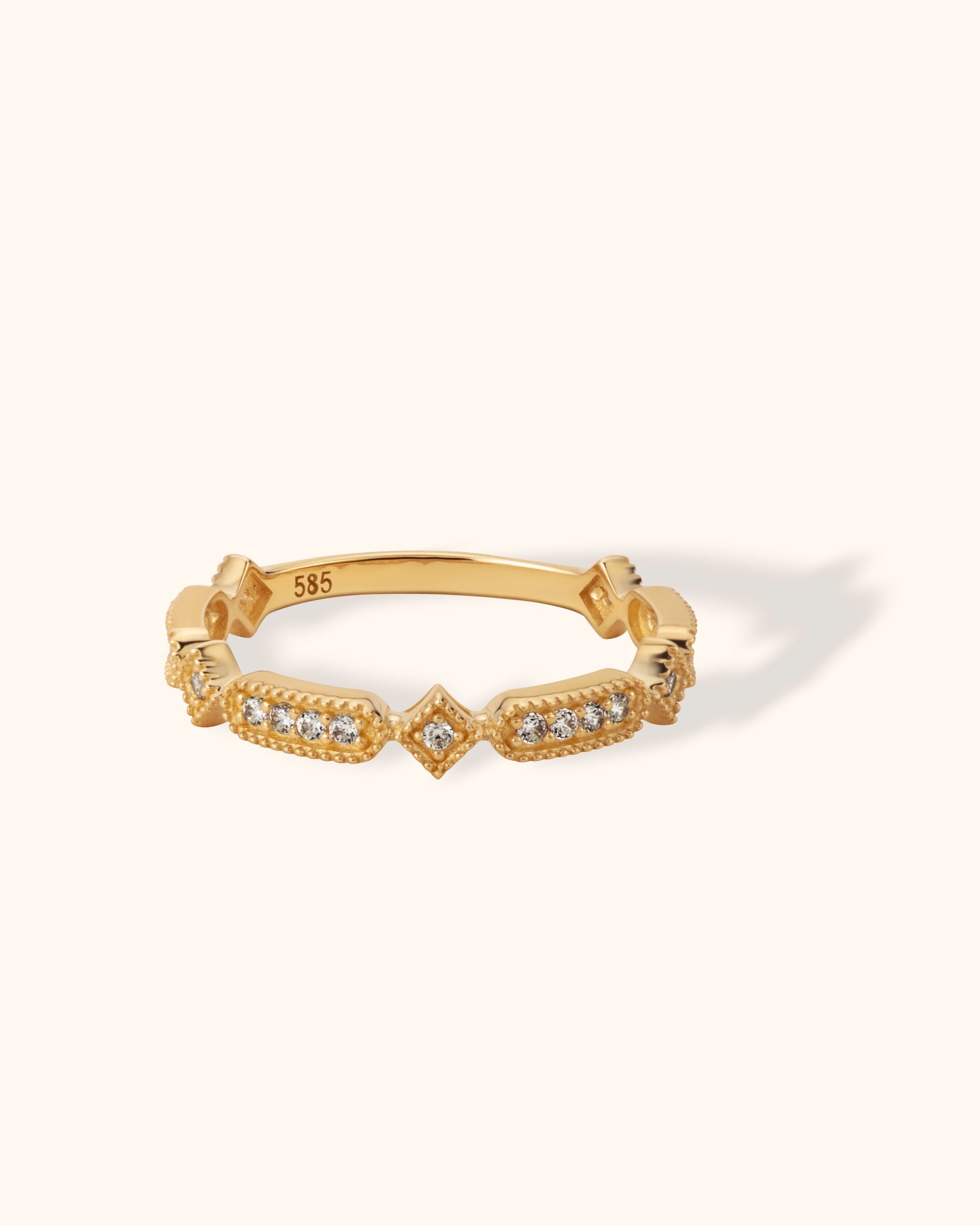 Vintage-inspired 14K gold ring with milgrain detail and diamond accents in geometric settings
