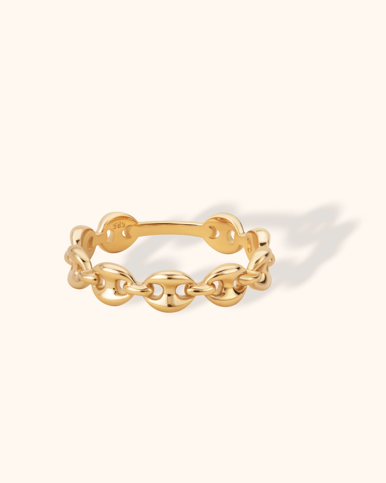Minimal 14k gold ring with chain link design on a light cream background

