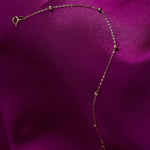 Minimal 14K gold bracelet with small Dorika beads on purple satin