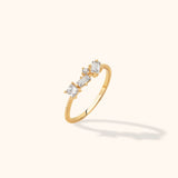 14K gold ring with twisted band and multi-cut diamond cluster including baguette, princess, and round shapes
