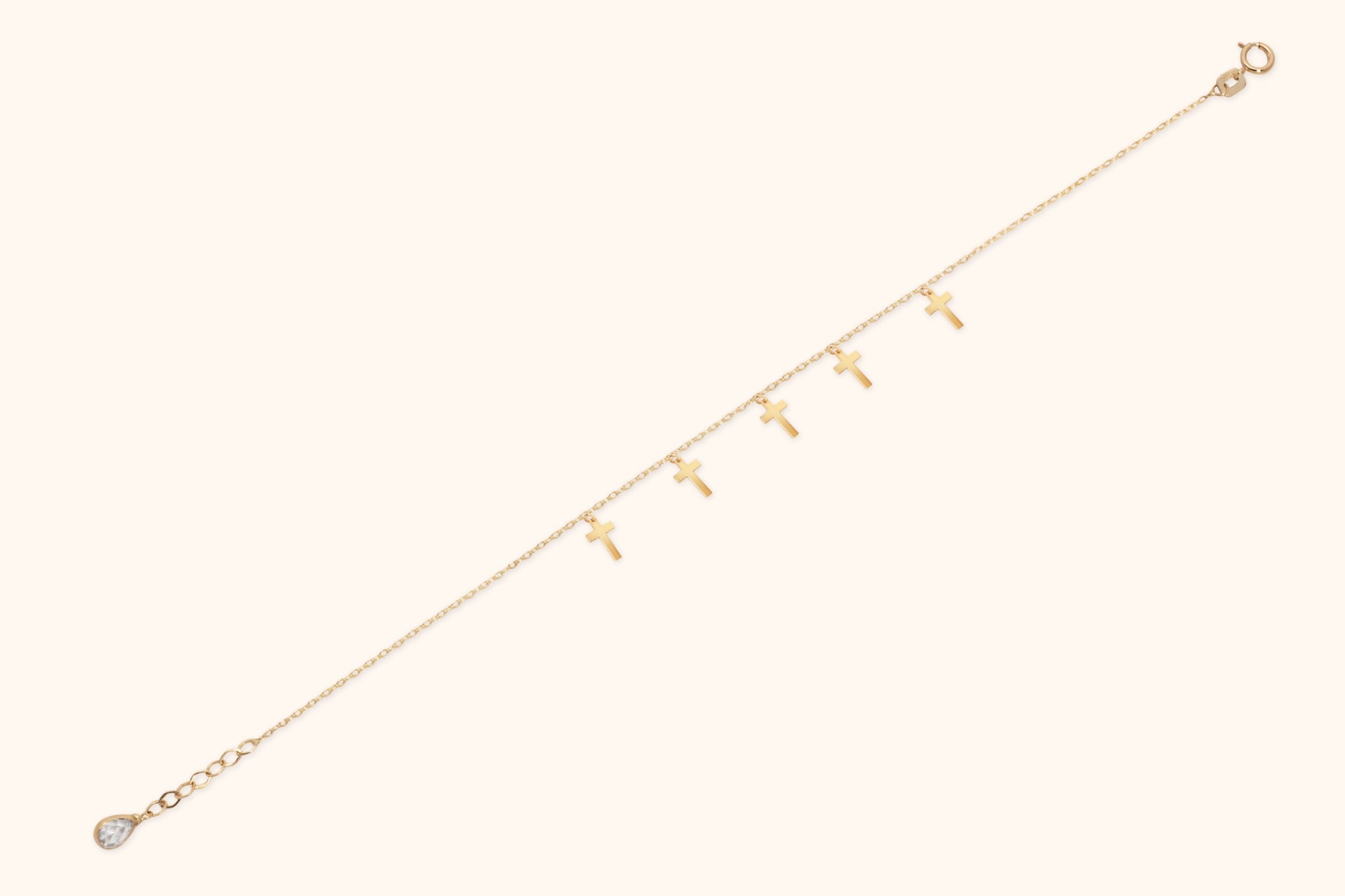 Minimalist bracelet with six cross charms crafted in 14K gold, displayed on a neutral background