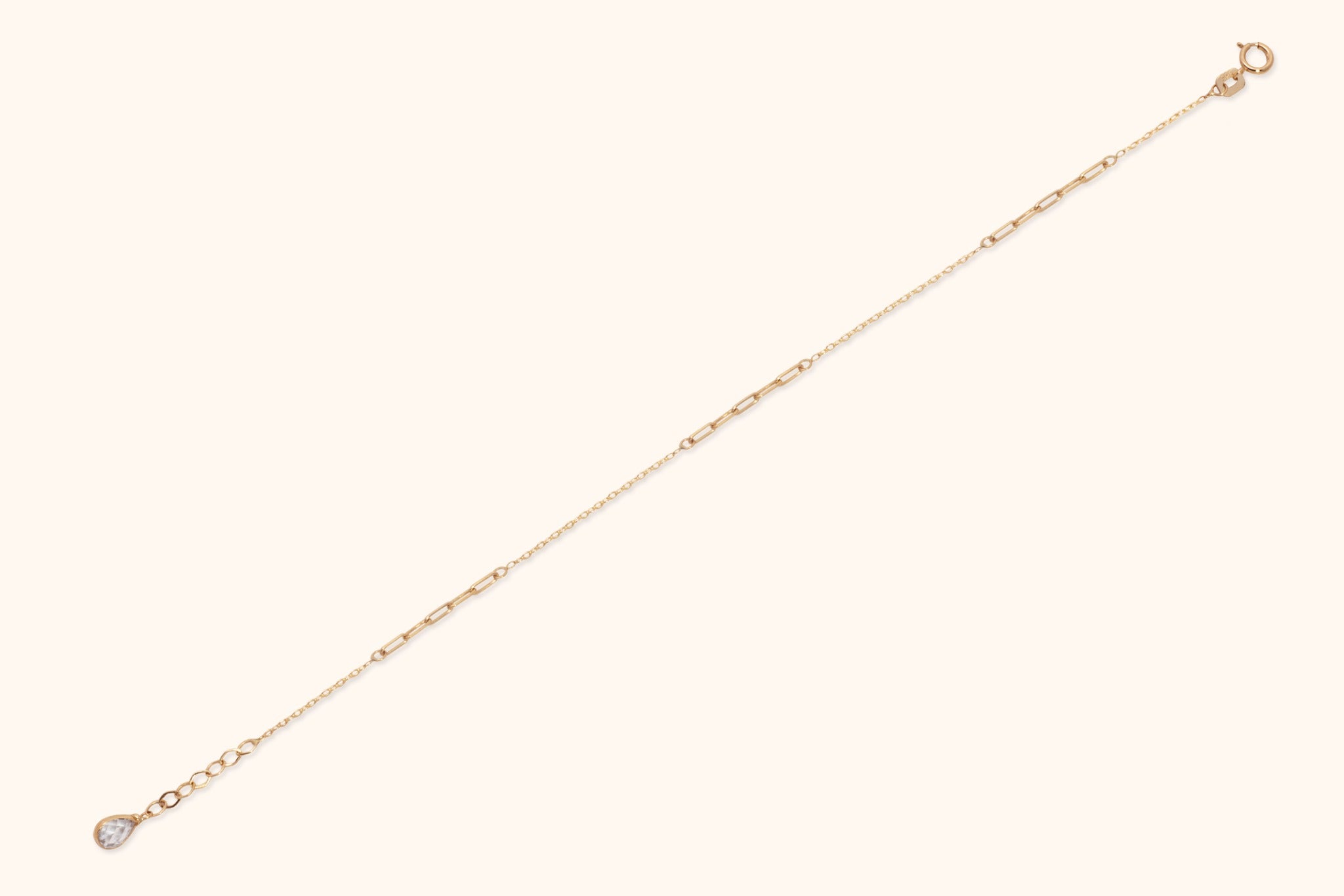 Solid 14K gold paperclip chain bracelet with minimalist link design on white background